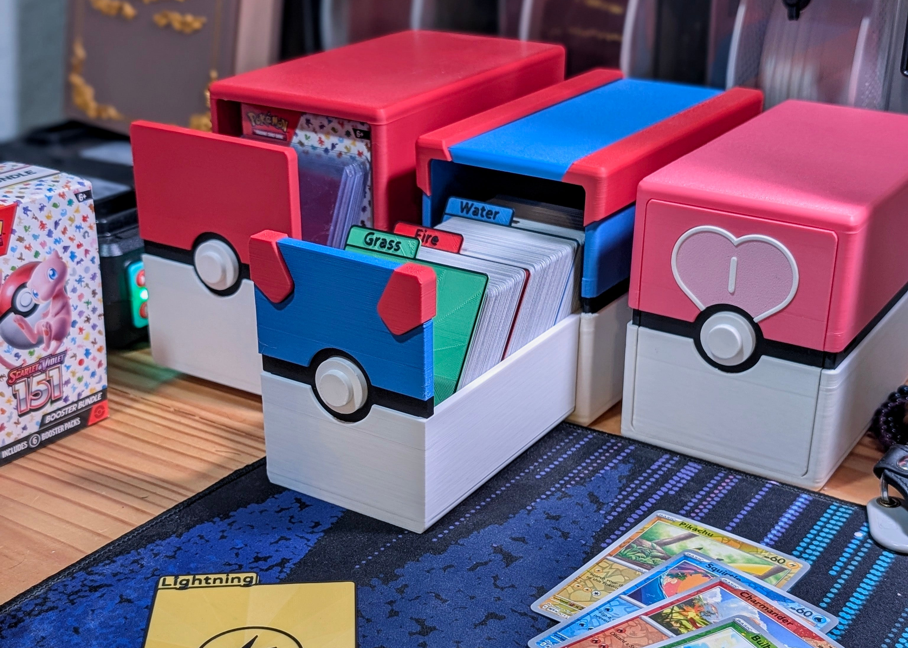 A front view of the Pokemon Card Storage system, showcasing the Poke Ball, Great Ball, and Love Ball designs.